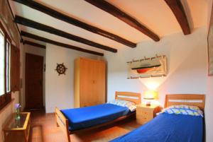 a bedroom with two beds with blue sheets at Club Villamar - Descanso in Platja  d'Aro +8 photos