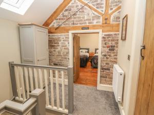 a staircase in a room with a brick wall at The Old Coach House in Mold