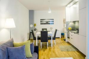 a kitchen and a dining room with a table in a room at Apartment Šola in Zagreb