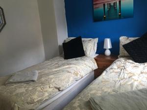 a bedroom with two beds with a pillow on it at City Living in Norwich