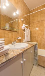 a bathroom with a sink and a mirror at Iberlagos in Lagos