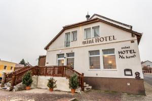 a large white building with amill hotel written on it at Mini hotel Na konci in Krupka - Marsov
