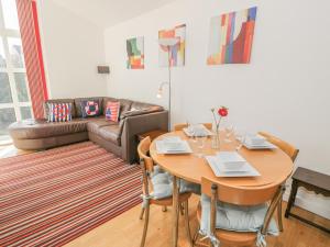 a living room with a table and a couch at Seaview in Benllech