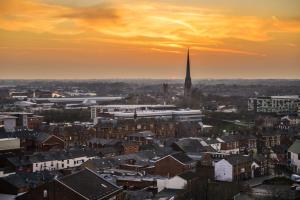 a view of a city with a church steeple at sunset at 6Adelphi in Preston