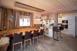 a kitchen and dining room with a table and chairs at Kreischberg Chalet in Murau in Murau