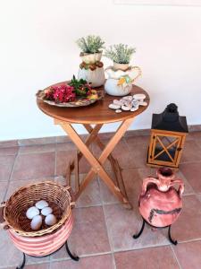 a table with plants and a basket of eggs on it at Oleander, 100m from the center and the sea in Sami