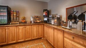 a kitchen with wooden cabinets and a counter top at Bryson Inn in Mount Airy