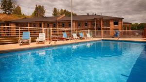 a large swimming pool with chairs and a building at Bryson Inn in Mount Airy