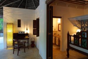 a living room with a table and a dining room at The Red Pepper House in Lamu +36 photos