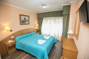 Postel nebo postele na pokoji v ubytování Hotel PAYRO