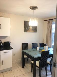 a kitchen and dining room with a table and chairs at Pendleton in Peterborough