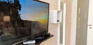 a large flat screen tv sitting on a wall at R1103ERI by euroresort in Marsalforn