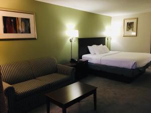 A bed or beds in a room at Ramada by Wyndham Batesville