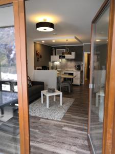 a living room and kitchen with a couch and a table at Berghaus Glockner, App. Niedermeyer in Heiligenblut