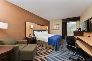 a hotel room with a bed and a desk at Holiday Inn Cody - Convention Center by IHG in Cody