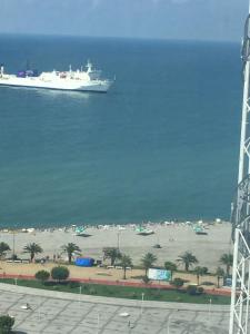 a cruise ship in the ocean with a beach at batumi porta tower 1811 in Batumi
