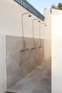 a bathroom with three towel racks on a wall at la meridiana 2 in Santa Maria al Bagno
