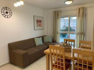 ein Wohnzimmer mit einem Sofa und einem Tisch in der Unterkunft Bea Laguna Beach Vera Playa - Gratis Jacuzzi in Vera