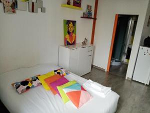 a bedroom with a bed with a colorful blanket on it at Grand studio au bord de l'eau in Saint Malo