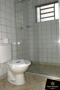a bathroom with a toilet and a shower at Hotel Nobre Requinte in Arujá +32 photos