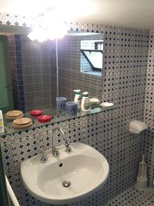 a bathroom with a sink and a mirror at Casa Tamurrà in Galati Mamertino