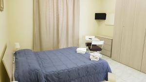 - une chambre avec un lit bleu et un bureau dans l'établissement A due passi da Dante, à Naples