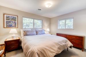 a bedroom with a bed and two windows at Country Club Retreat in South Lake Tahoe