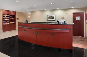 a lobby of a hospital with a reception counter at Hawthorn Suites by Wyndham College Station in College Station