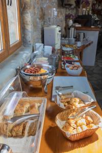 a table with various types of pastries and other foods at Villa Konstantin in Mýkonos City