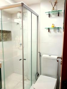 La salle de bains est pourvue d'une douche en verre et de toilettes. dans l'établissement Israel Flat Tambau 209 PRIME, à João Pessoa
