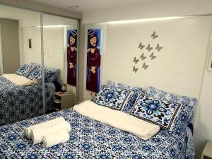 a bedroom with two beds and birds on the wall at Israel Flat Tambau 209 PRIME in João Pessoa +16 photos