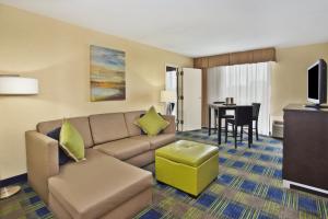 a living room with a couch and a table at Holiday Inn Akron-West by IHG in Montrose