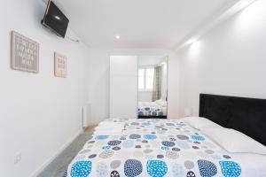 1 dormitorio con 1 cama con edredón azul y blanco en Luizinho House en Vila Nova de Gaia