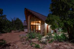 a house in the bush at night at Pilanesberg Private Lodge in Pilanesberg