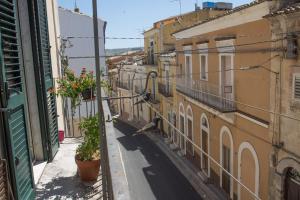 un vicolo con edifici e piante su una strada di Casa verde Dafni a Ragusa