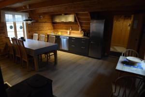 a kitchen with a table and chairs in a room at Lofoten Cabins - Sund in Sund