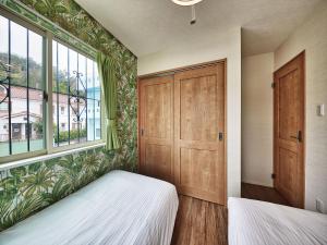 a bedroom with two beds and a window at Private Villa Espacio Onna in Inbu +28 photos
