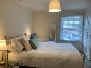 a bedroom with a large bed and a window at The Salisbury Townhouse in Salisbury