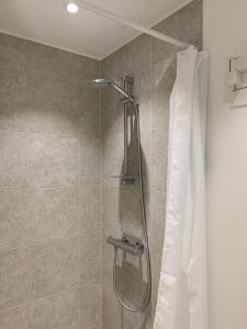 a shower in a bathroom with a shower curtain at ApartmentInCopenhagen Apartment 1440 in Copenhagen