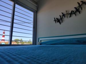 a bedroom with a blue bed and a lighthouse at Luz de faro in Mar del Plata