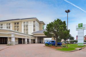 a hotel with a blue car parked in front of it at Holiday Inn Dallas-Richardson by IHG in Richardson