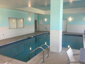 a pool at a hotel with a chair and a table at Holiday Inn Cincinnati North West Chester by IHG in West Chester