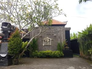 a building with a sign on the side of it at Alit Bali Villa in Canggu