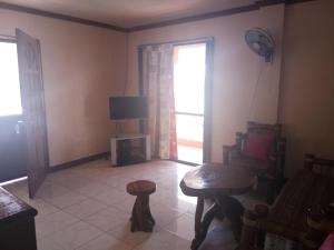 a living room with a chair and a television at VRC Resort in Almeria +8 photos