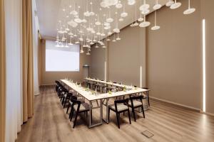 a long dining room with a long table and chairs at Holiday Inn Dresden - Am Zwinger, an IHG Hotel in Dresden