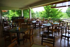 a restaurant with tables and chairs on a balcony at Mae Jo Golf Resort & Spa in San Sai