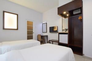 Postel nebo postele na pokoji v ubytování Kepong Hotel