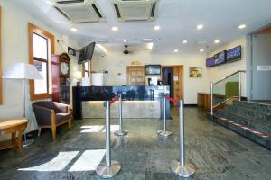 a lobby with a bar and stairs in a restaurant at Kepong Hotel in Kuala Lumpur