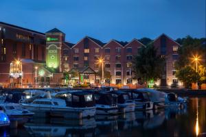 a group of boats docked in a marina at night at Holiday Inn Lincoln, an IHG Hotel in Lincoln