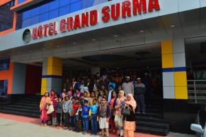 a crowd of people standing in front of a building at Grand Surma Hotel in Sylhet
